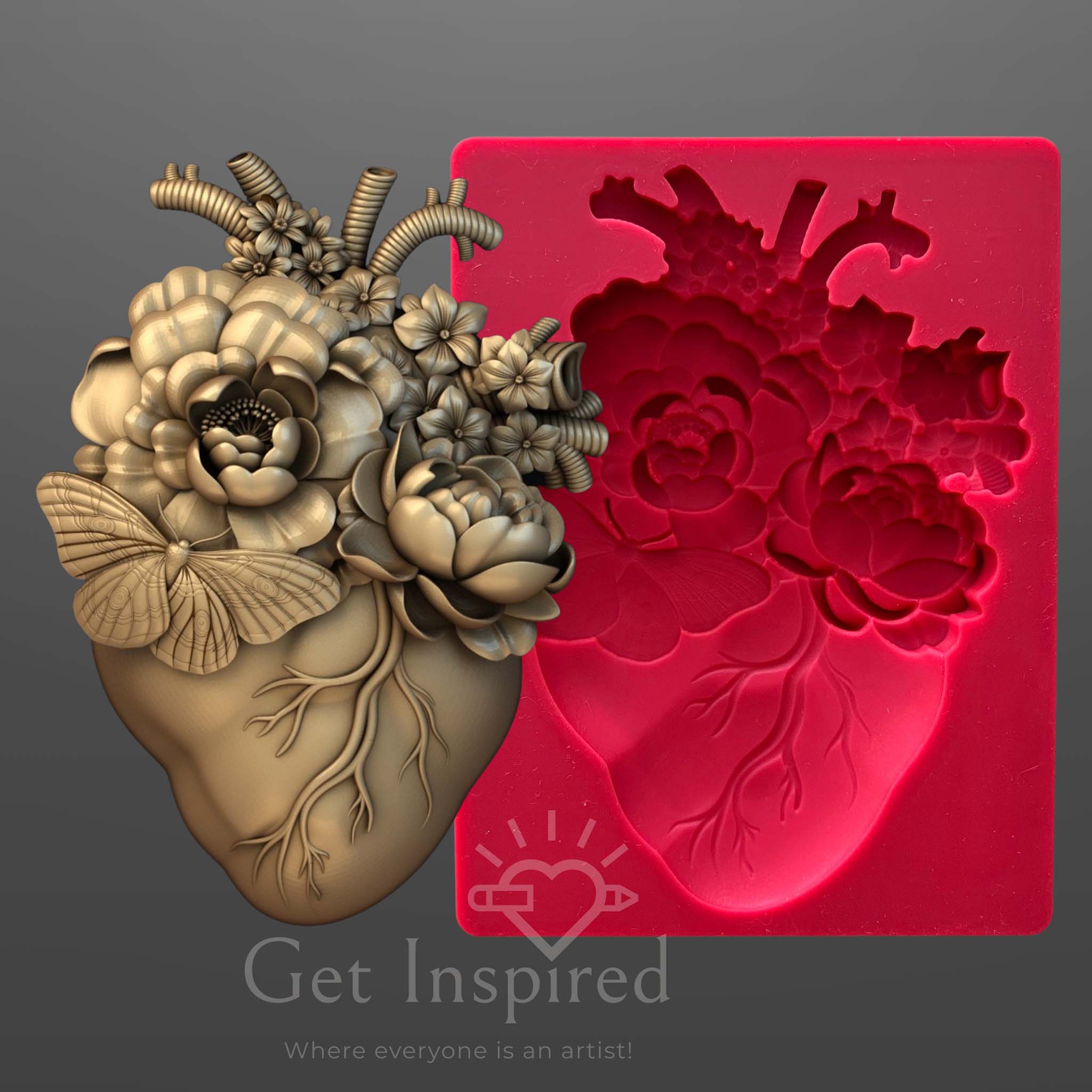 A red silicone mold and gold colored casting of an anatomical heart with flowers coming out of it are against a dark grey background.