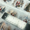 Christmas-themed decoupage paper with Santa Claus illustrations and a ruler for scale.