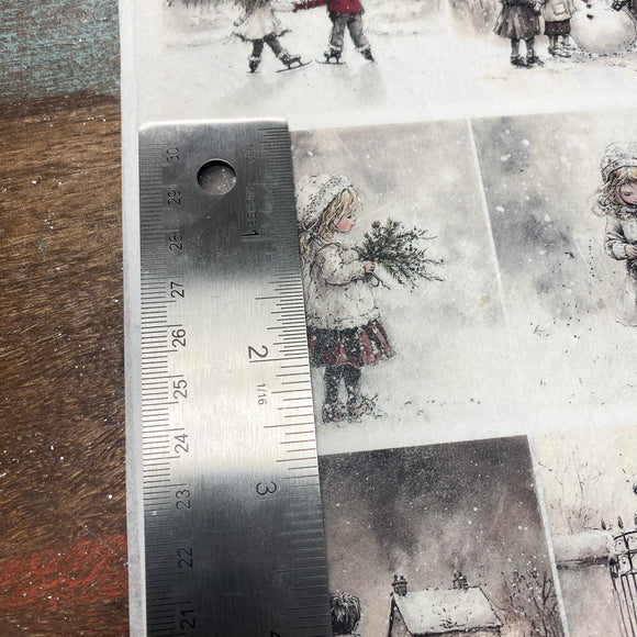 Ruler next to a snowy scene illustration with children and a snowman.