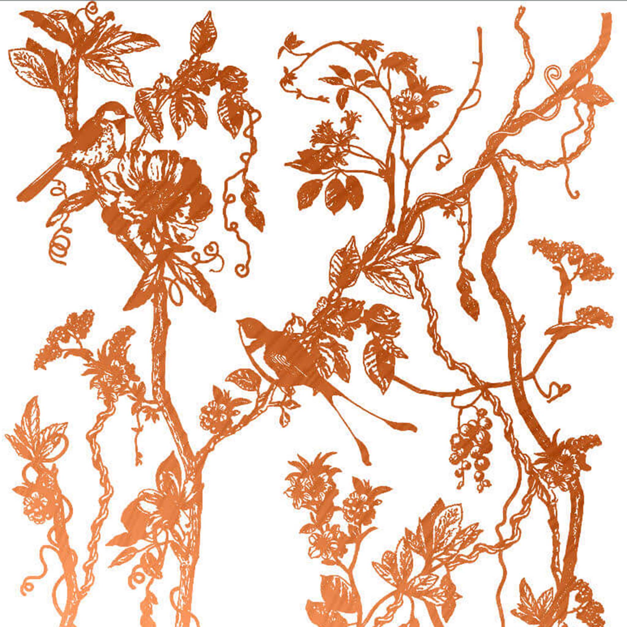 Close-up of a copper foil transfer design featuring charming birds perched on blooming branches and vines is against a white background.