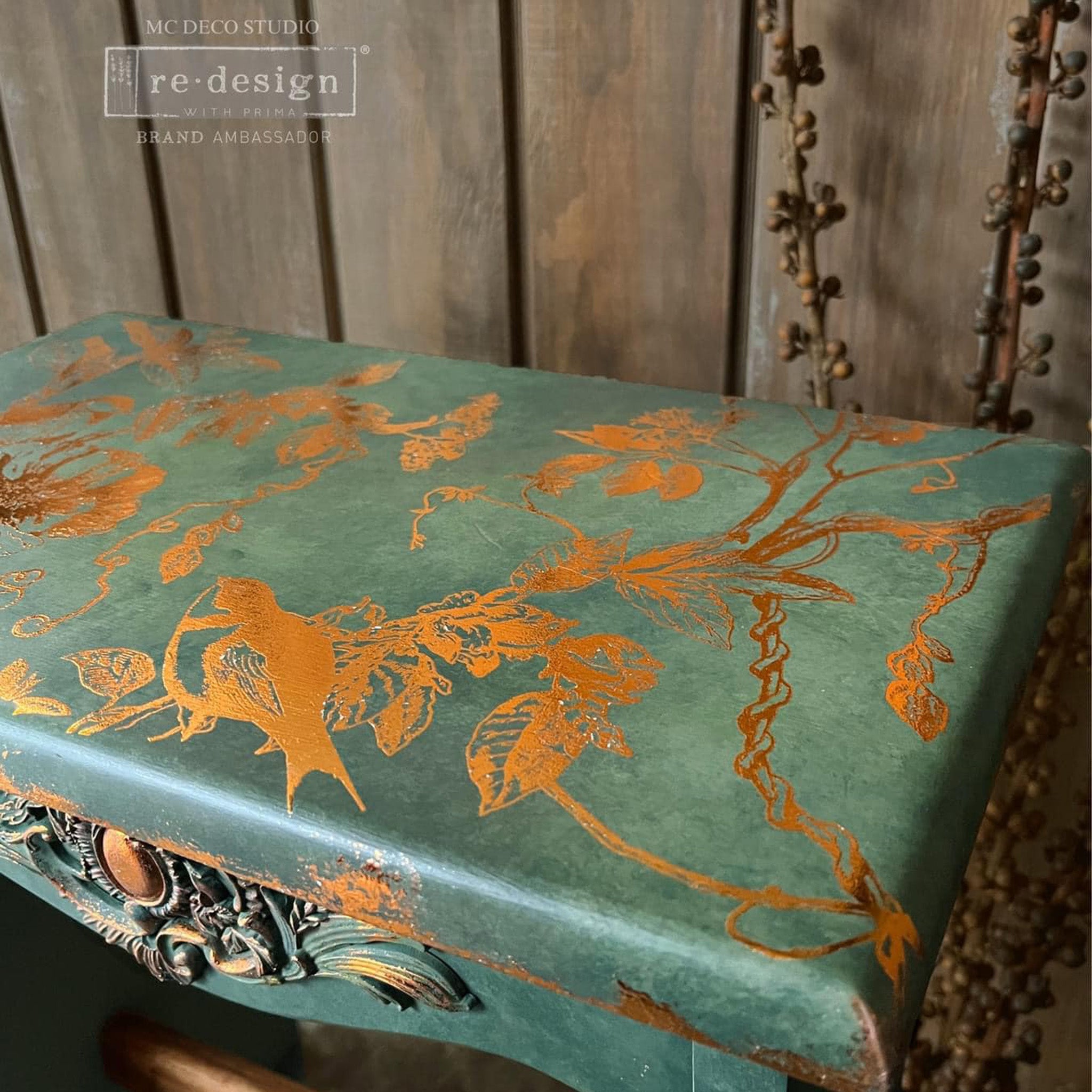 A vintage desk refurbished by MC Deco Studio is painted green and features ReDesign with Prima's Kacha's Bird Watching Copper Foil transfer on it.