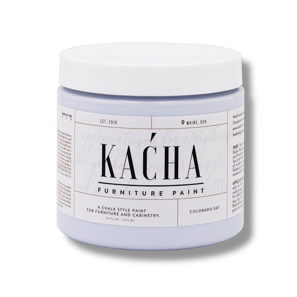 A 16 oz container of Kacha Furniture Paint in the color Colorado Sky (soft pale blue) is against a white background.