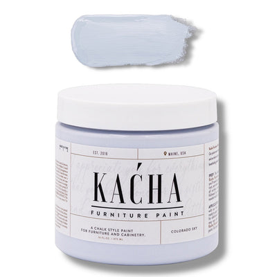 A 16 oz container and swatch sample of Kacha Furniture Paint in the color Colorado Sky (soft pale blue) is against a white background.