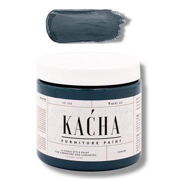 A 16 oz container and swatch sample of Kacha Furniture Paint in the color Danube (moody blue-green) is against a white background.