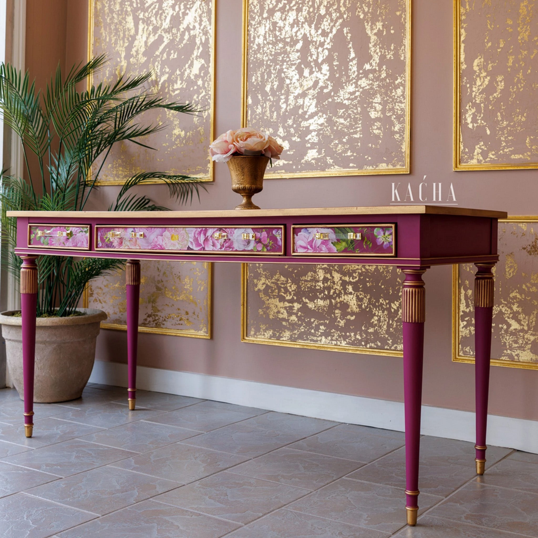 A vintage console table refurbished by KACHA features KACHA Pink furniture paint with gold accents and pink floral details.