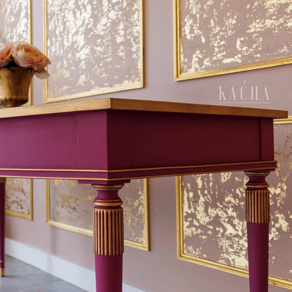 A close-up of a vintage console table refurbished by KACHA features Kacha Pink furniture paint with gold accents.