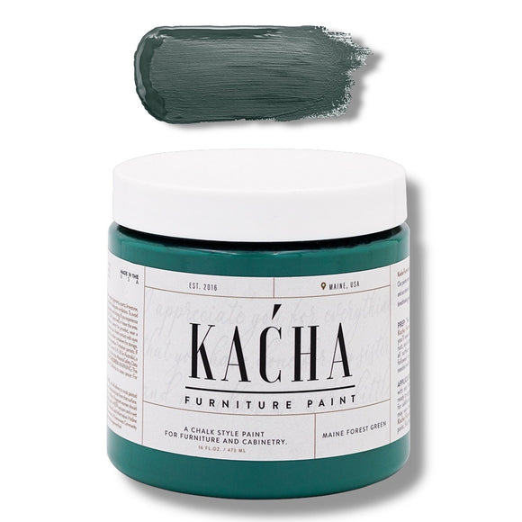 A 16 oz container and swatch sample of Kacha Furniture Paint in the color Maine Forest Green is against a white background.
