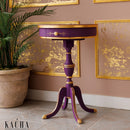 A vintage round side table refurbished by Kacha features Kacha Purple Emperor paint with gold trim details.