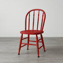 A wood chair with an arched back with spindles is painted in KACHA Rouge Red furniture paint.