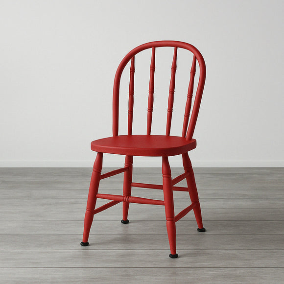 A wood chair with an arched back with spindles is painted in KACHA Rouge Red furniture paint.