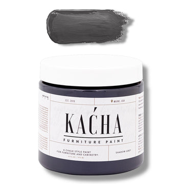 A 16 oz container and swatch sample of Kacha Furniture Paint in the color Shadow Grey (charcoal) is against a white background.