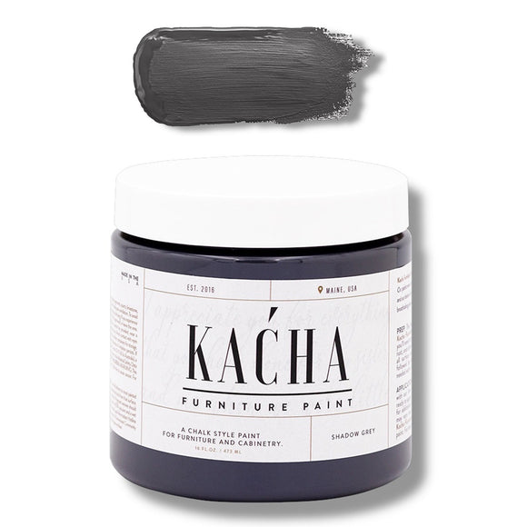 A 16 oz container and swatch sample of Kacha Furniture Paint in the color Shadow Grey (charcoal) is against a white background.