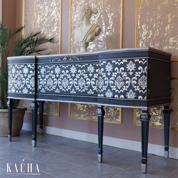 A vintage console table refurbished by Kacha features Kacha Furniture Paint in the color Siva Grey with a damask design in white on it.