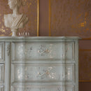 A close-up of a vintage large dresser refurbished by Kacha features Kacha South Beach paint with silver details.