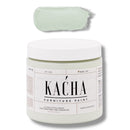 A 16 oz container and swatch sample of Kacha Furniture Paint in the color Subtle Pistachio (pale green) is against a white background.