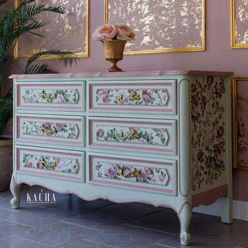 A vintage large 6-drawer dresser refurbished by Kacha features Kacha Subtle Pistachio paint and have pink and floral details.