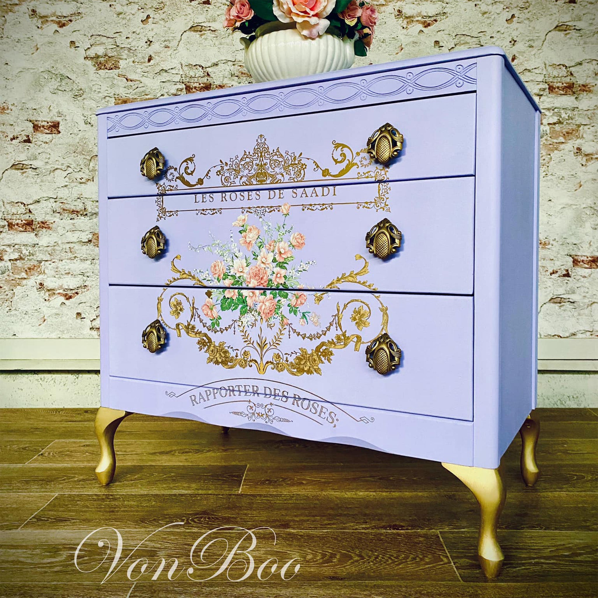 A vintage 3-drawer dresser refurbished by Von Boo is painted pastel purple and features ReDesign with Prima's Kacha Les Roses rub on transfer on the front.