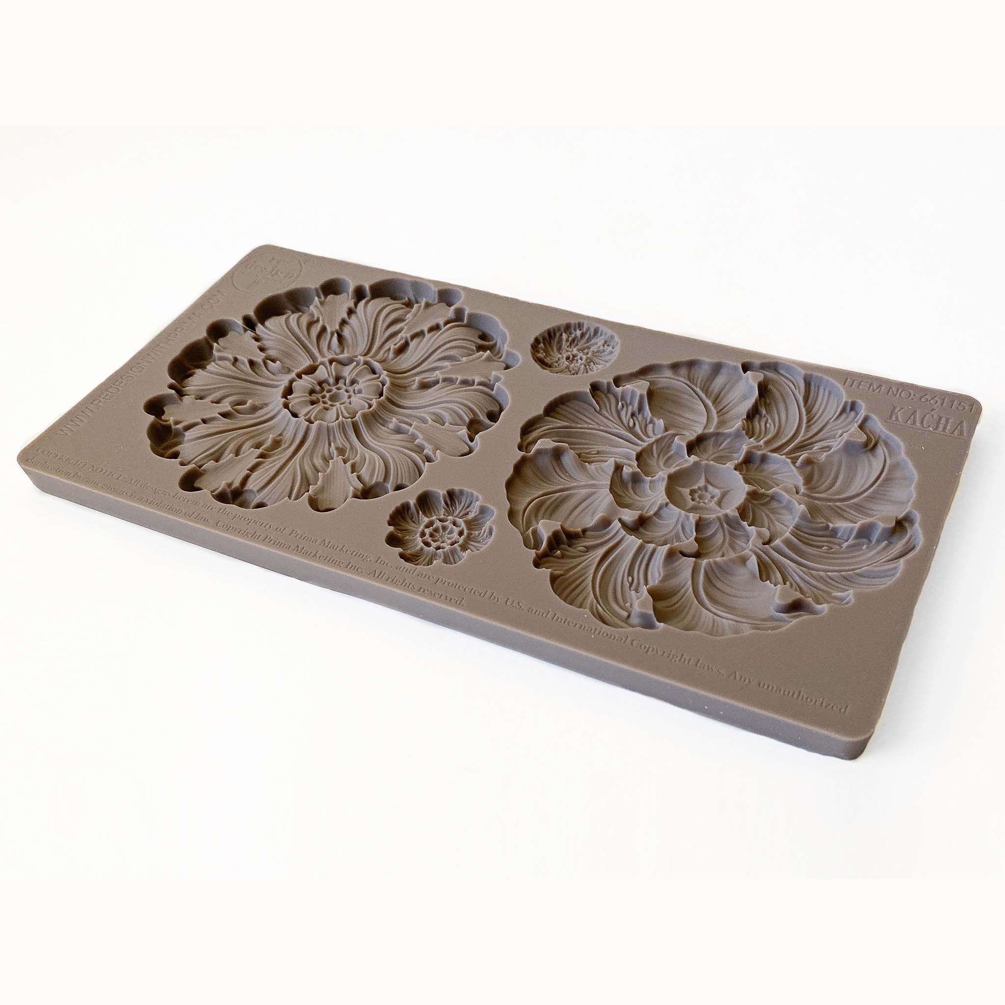 A brown silicone mold of 2 large and 2 small floral medallions is against a white background.