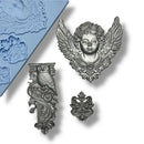 Silver painted pieces including an angel head, owl, and other intricate designs on a white background.