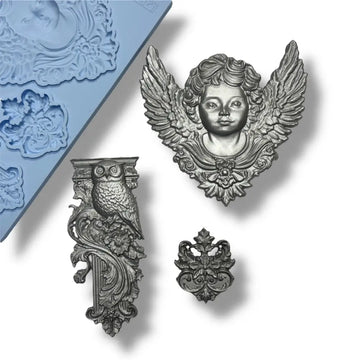 Silver painted pieces including an angel head, owl, and other intricate designs on a white background.