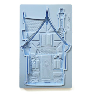 A blue silicone mould of LaBlanche's Fairy House is against a white background.