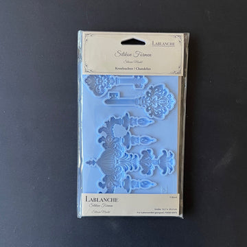 A package of LaBlanche's Chandelier and Keys silicone mold is against a dark grey background.