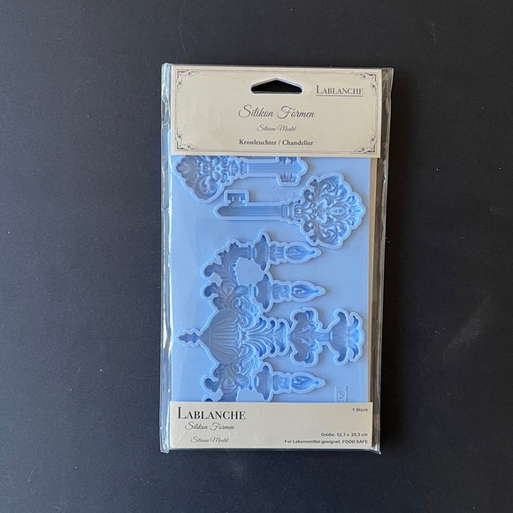 A package of LaBlanche's Chandelier and Keys silicone mold is against a dark grey background.