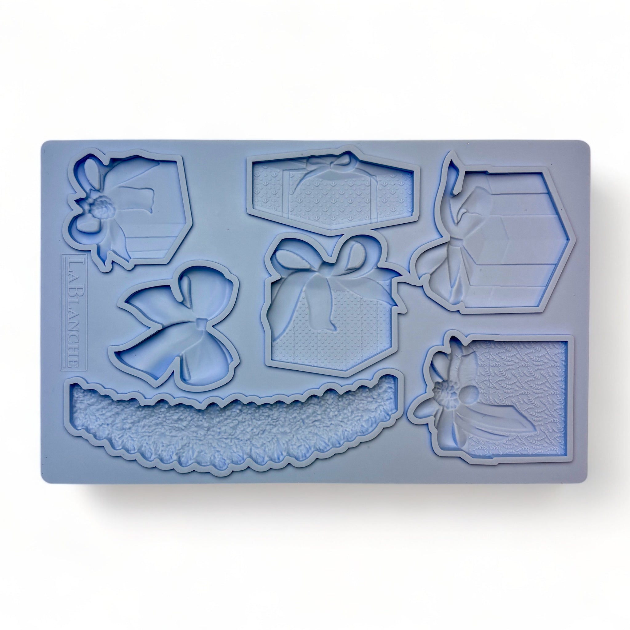 A blue silicone mold of 5 beautifully wrapped packages, complete with a large bow and garland is against a white background.