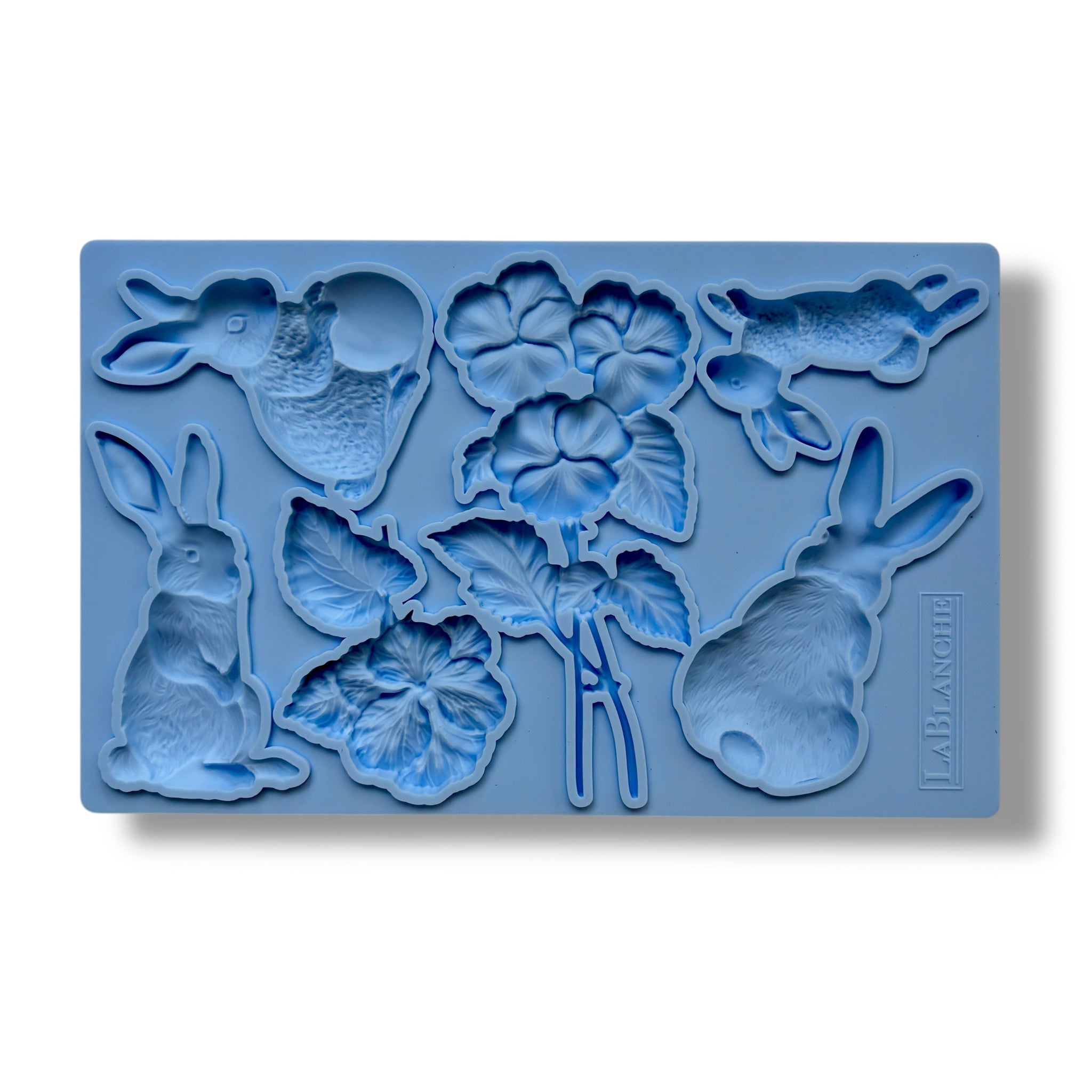 A blue silicone mold featuring bunnies and flowers are against a white background.