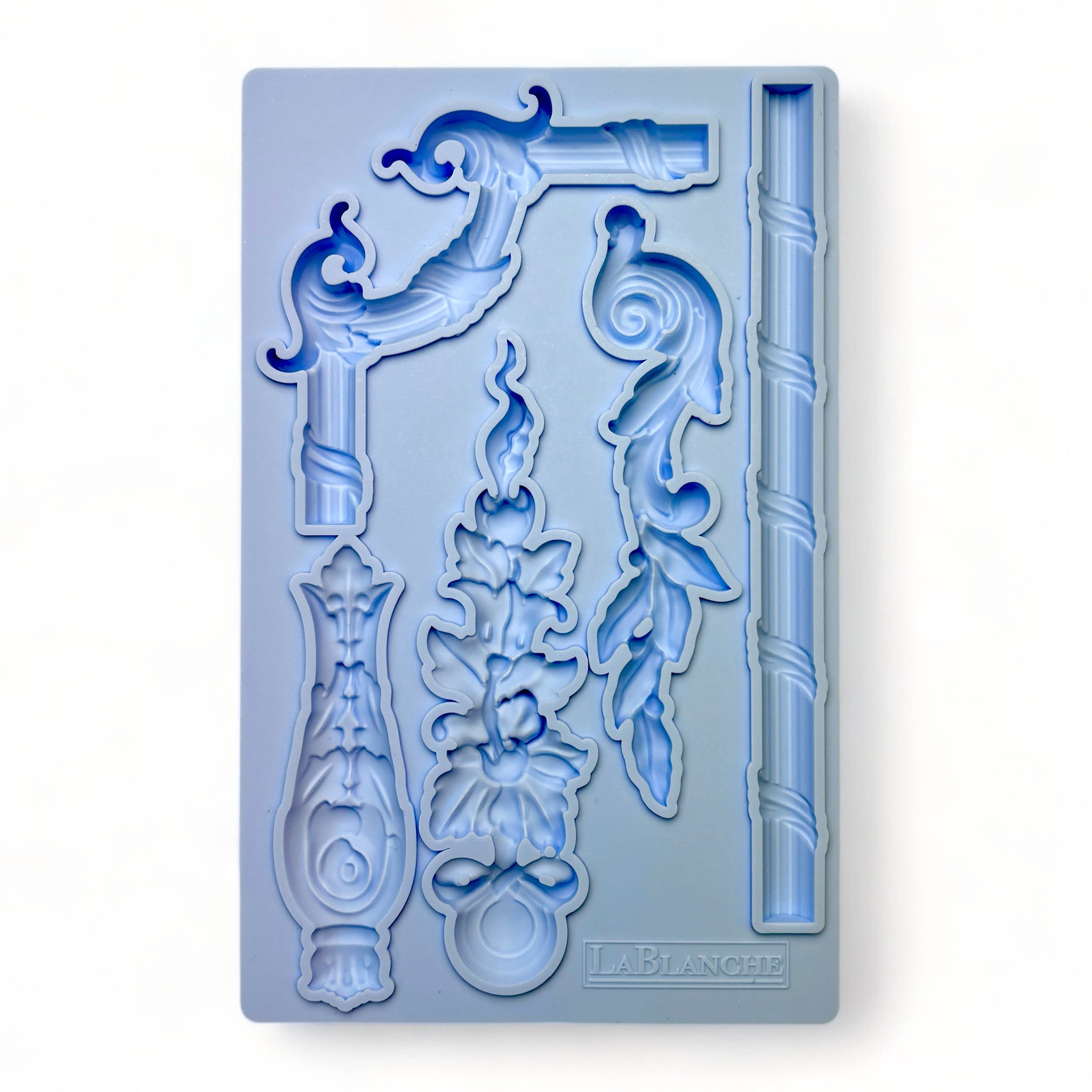 A blue silicone mold of 5 ornate border trim and accent pieces is against a white background.