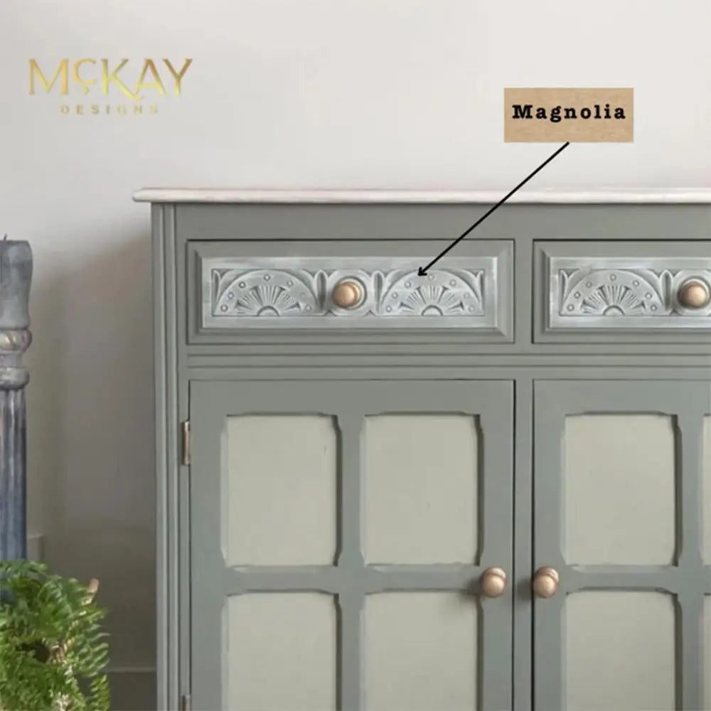 A close-up of a buffet table features Dixie Belle's Magnolia Chalk Mineral Paint as a white-wash on some drawer details.