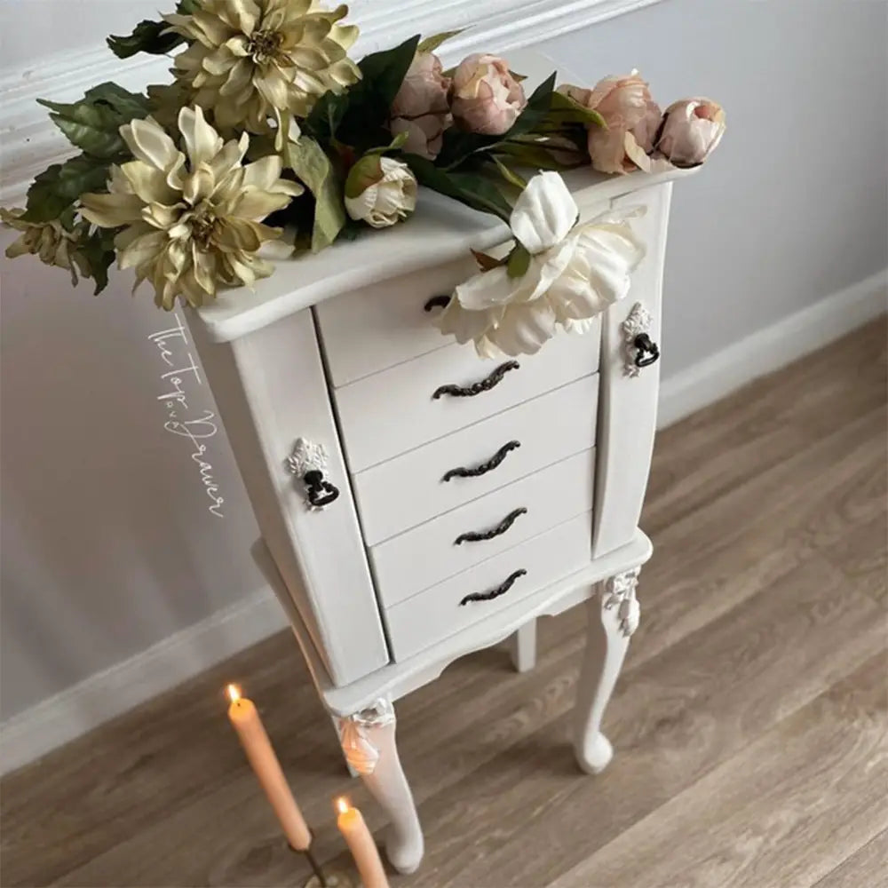 A vintage standing jewelry armoire refurbished by The Top Drawer is painted in Dixie Belle's Magnolia Chalk Mineral Paint.