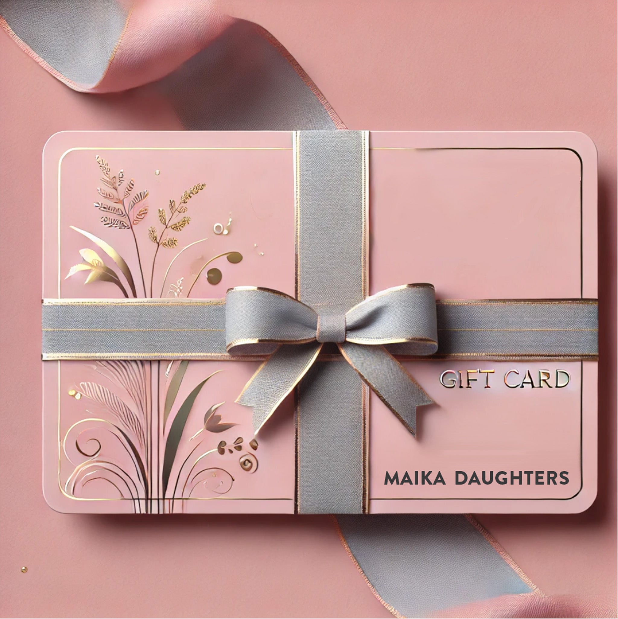 A light pink gift card with gold foil flowers and a grey bow around it that says Gift Card Maika Daughters is against a light pink background.