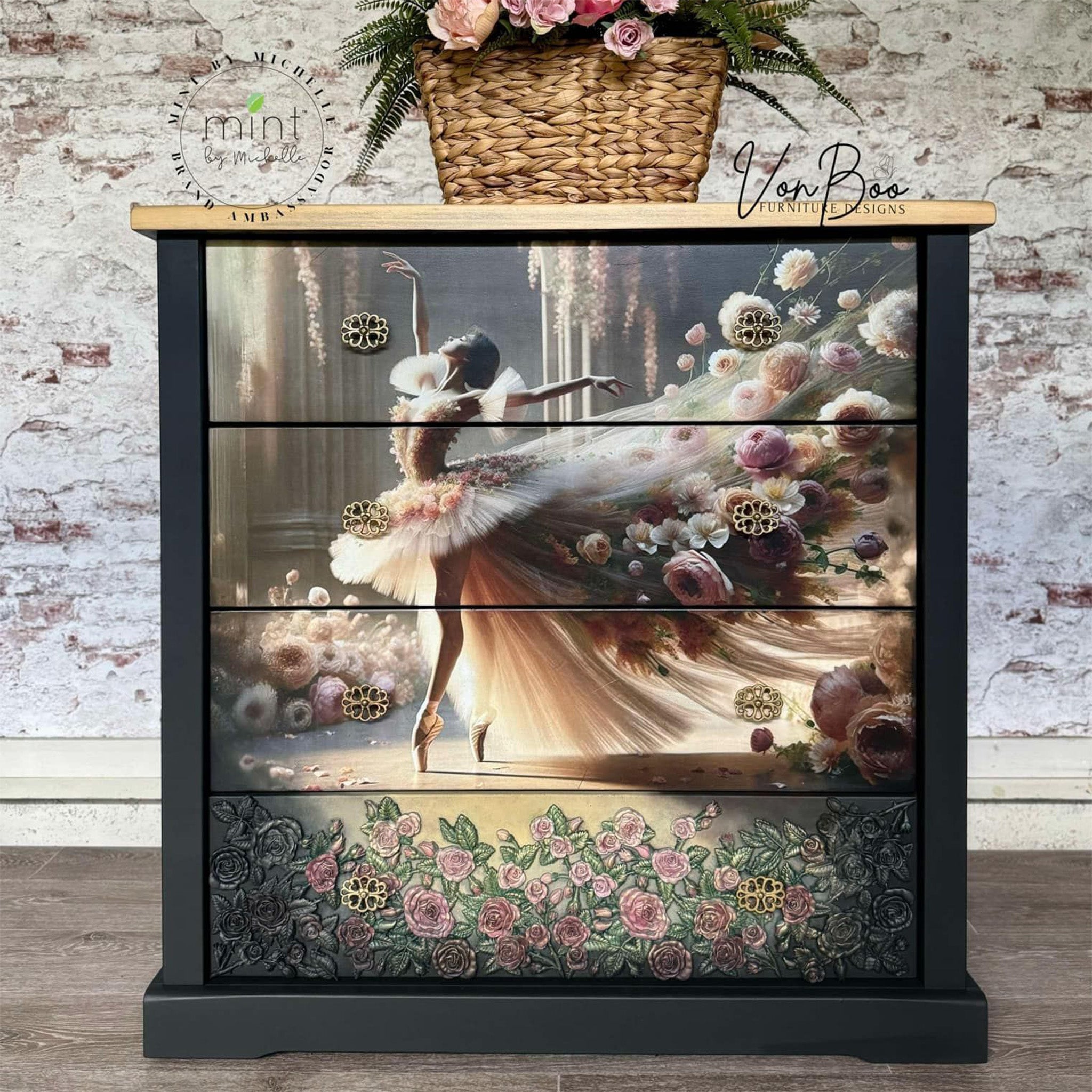 A 4-drawer chest dresser refurbished by Von Boo Furniture Designs is painted navy blue with a light natural wood top and features Mint by Michelle's Ballet in Bloom decoupage paper on the drawers.