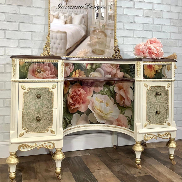 Decorative cabinet with floral design and gold accents against a brick wall.