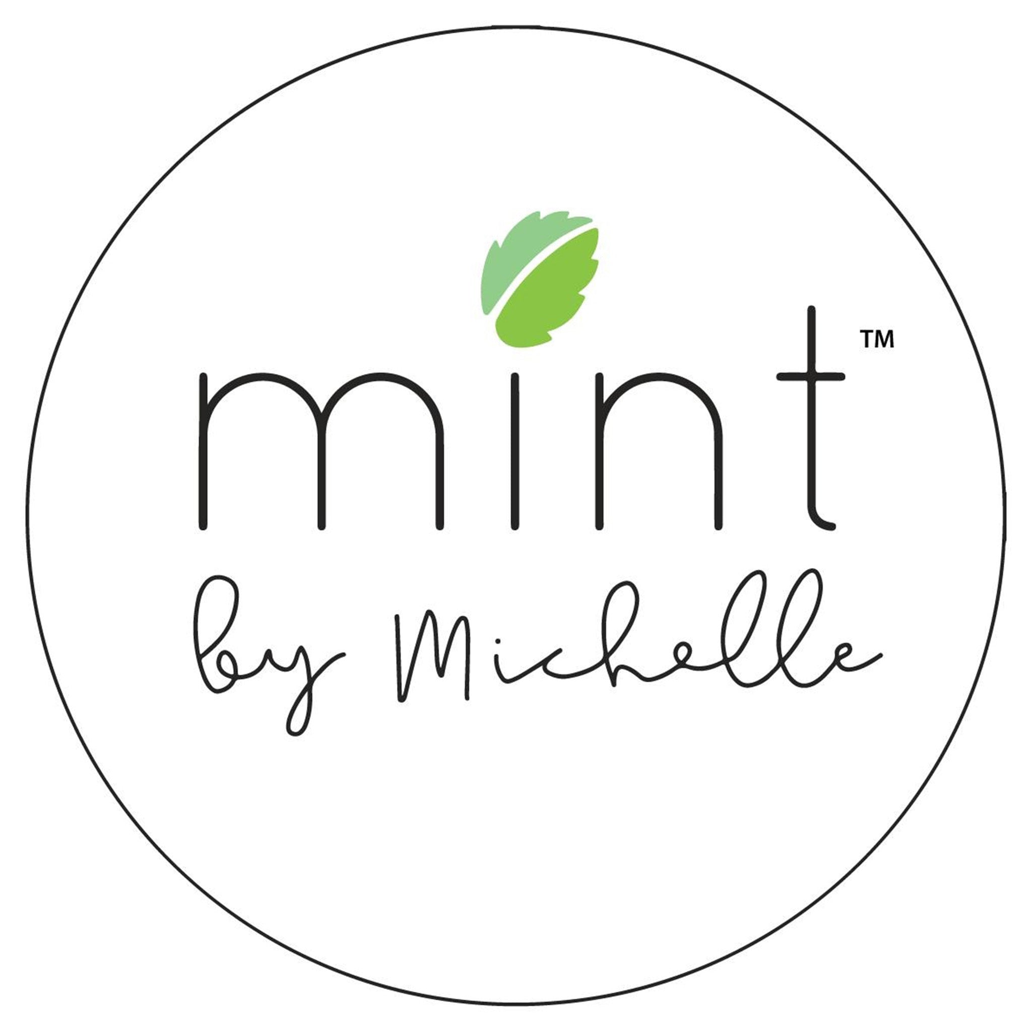 A white background has a simple black outlined circle with the words Mint by Michelle with a mint leaf above the letter I in mint.