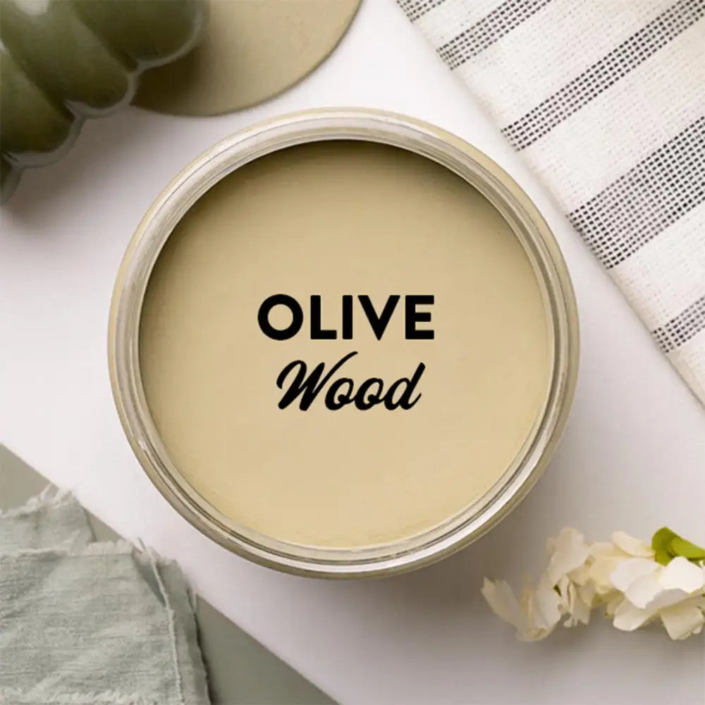 An arial view of an open container of Dixie Belle Paint Company's Olive Wood Chalk Mineral Paint is shown with black text reading Olive Wood.