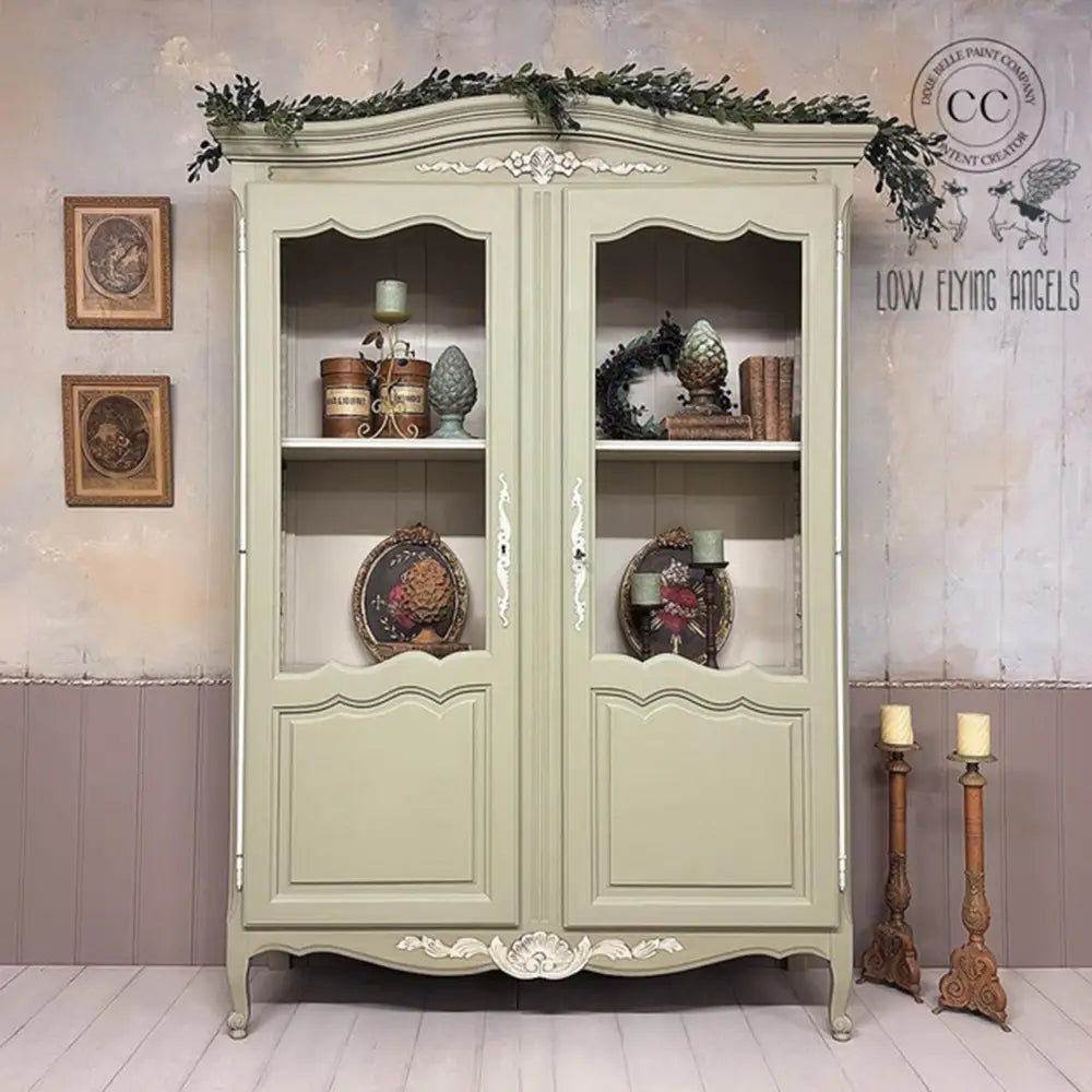 A vintage hutch cabinet refurbished by Low Flying Angels is painted in Dixie Belle's Olive Wood Chalk Mineral Paint.