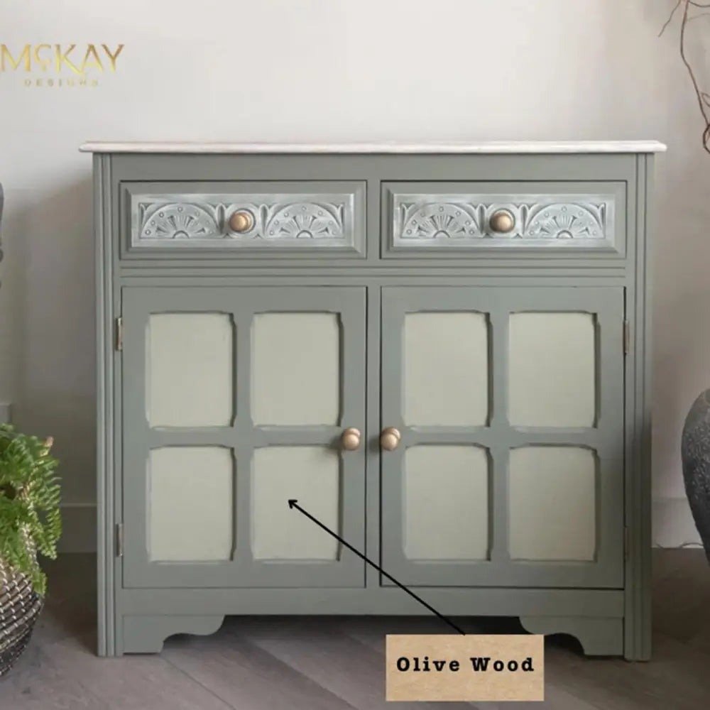 A small buffet cabinet refurbished by McKay Designs is painted in Dixie Belle's Thicket and features Dixie Belle's Olive Wood Chalk Mineral Paint on its 2 door inlays.