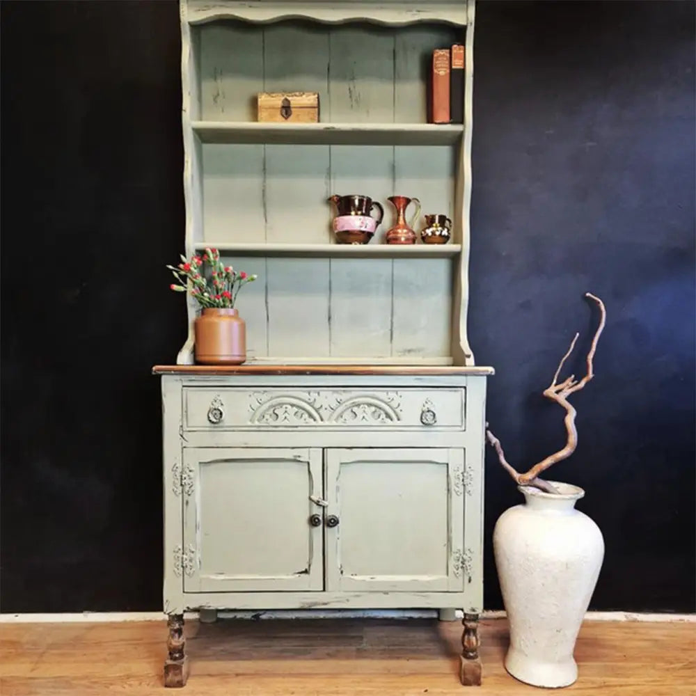 A vintage country style hutch is painted in Dixie Belle's Olive Wood Chalk Mineral Paint.