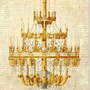 Close-up of a rice paper featuring an ornate gold chandelier design, hanging in front of a creamy vintage document with faded writing.
