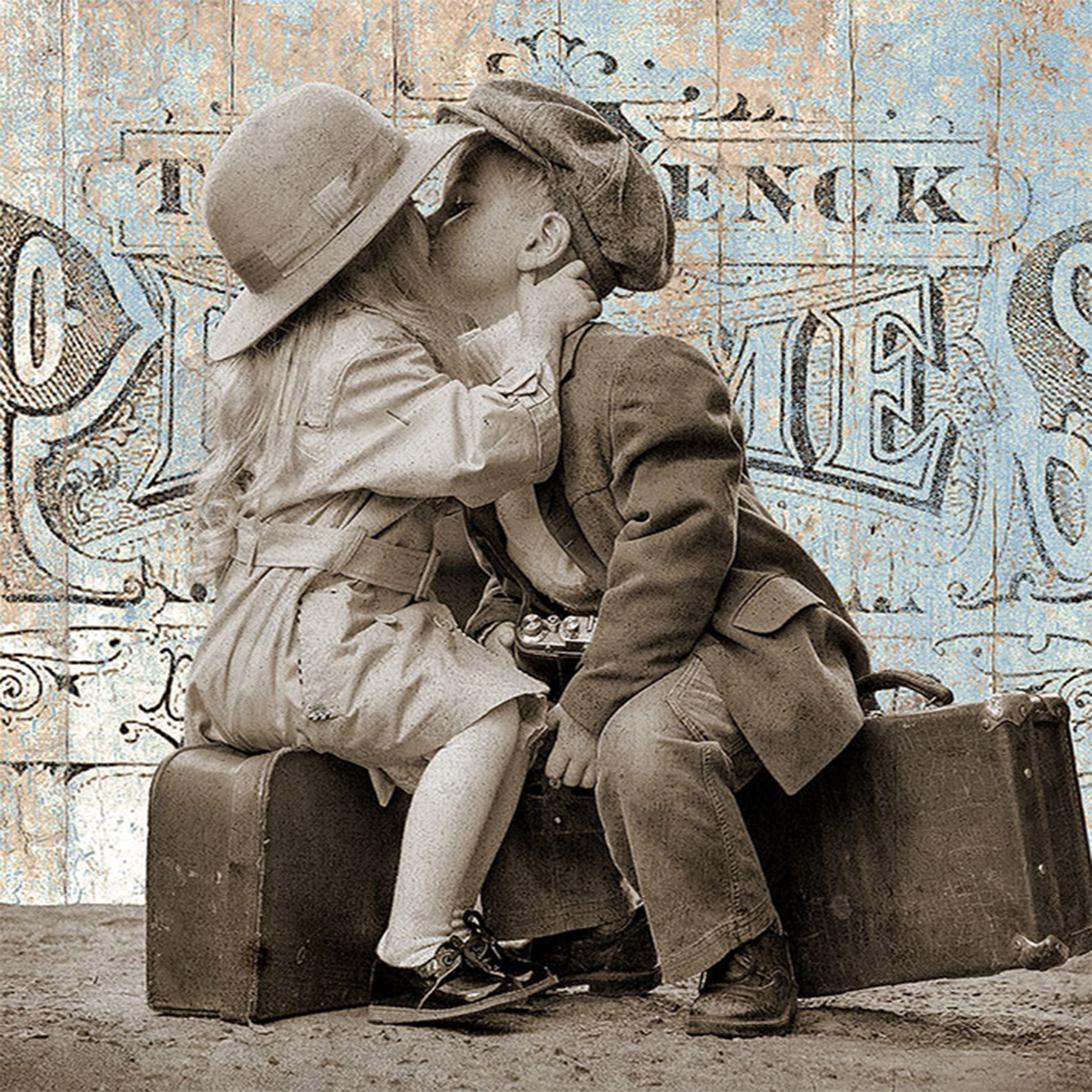 Close-up of a rice paper design that features a whimsical vintage illustration of two little kids sharing a kiss on a luggage.