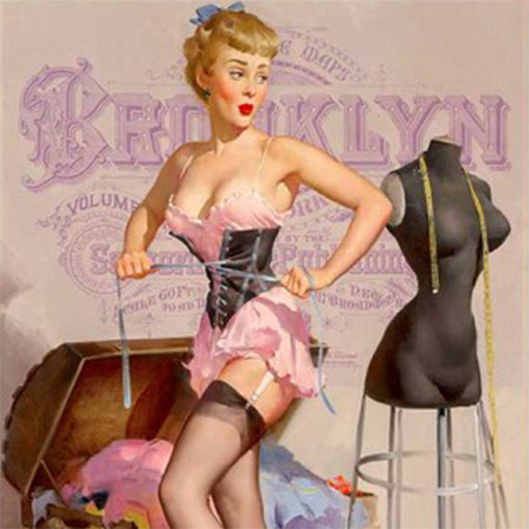 Close-up of a rice paper that features a playful image of a woman cinching her black corset next to a dress form and chest full of clothes.