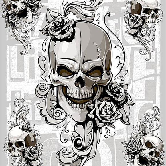 Close-up of a rice paper featuring a grey scale design of skulls and roses against scrolling flourishes with a touch of block text as the backdrop. 