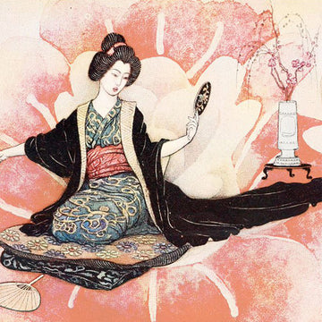 Close-up of a rice paper featuring a playful geisha kneeling on a rug looking in a hand mirror against a soft pink floral backdrop.