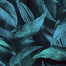 Close-up of a rice paper featuring glowing blue green tropical leaves against a sleek black backdrop.
