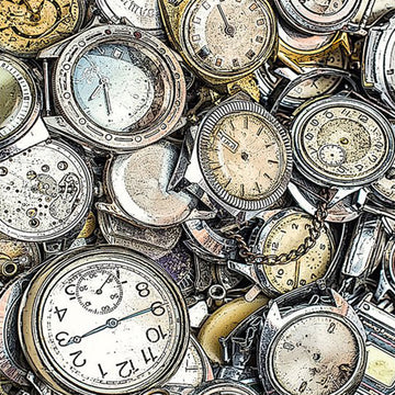 Close-up of a rice paper featuring a pile of vintage pocket watches.