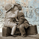 Close-up of Paper Designs Italy Vintage Suitcase Kiss A4 rice decoupage paper showing vintage children kissing on suitcases with distressed travel postcard background.