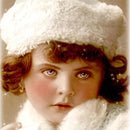 Close-up of a rice paper featuring a vintage portrait photograph of an adorable girl all snuggly in her white fur coat and matching hat, ready for frosty adventures.