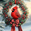 Red cardinal bird on a Christmas wreath with berries and a bow